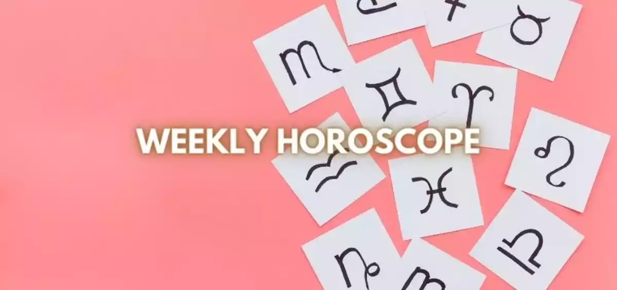 Papers with the signs of the zodiac on a pink background and the letters ''Weekly Horoscope''